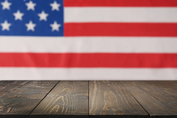 istock American blurred flag on wooden table top as background for Independence Day. 1487807716