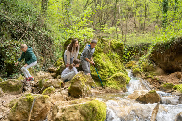 istock Happy Children Walking by Beautiful River While Hiking in Mountains 1487808842