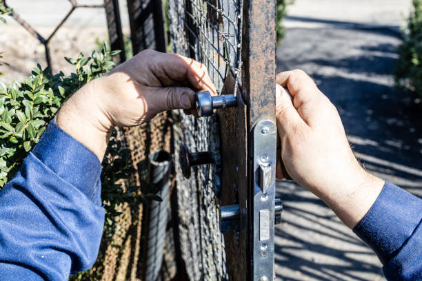 istock worker installs new door lock in iron gate closeup 1487809567