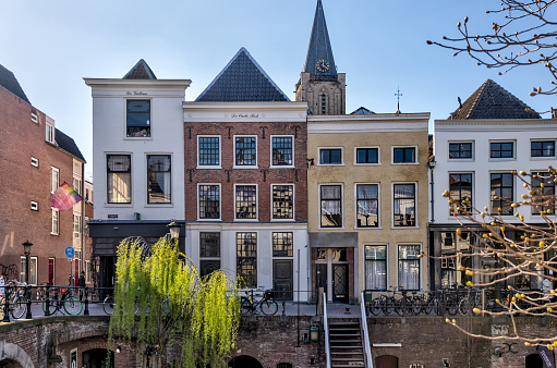 Utrecht, Netherlands - April 2, 2023: Tourists, shoppes and restaurants amidst classic architecture of the buildings in old town Utrecht