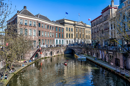 Utrecht, Netherlands - April 2, 2023: Tourists, shoppes and restaurants amidst classic architecture of the buildings in old town Utrecht