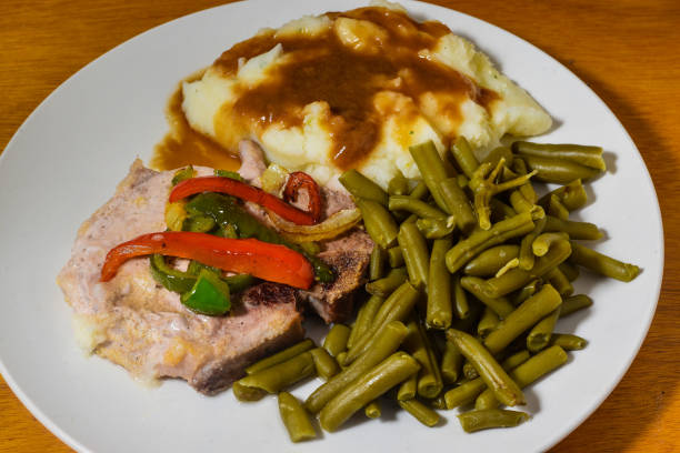 istock pork chop  top with sauteed onions and peppers 1487811622