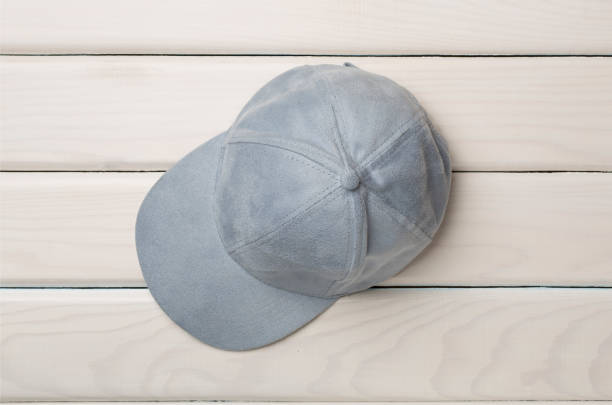 istock Blue cap on wooden background, top view. 1487813139