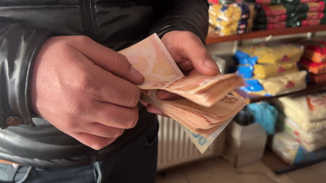 Man Counts 50 Lira Turkish Banknotes