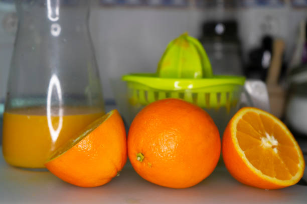 picture of oranges with an orange juicer