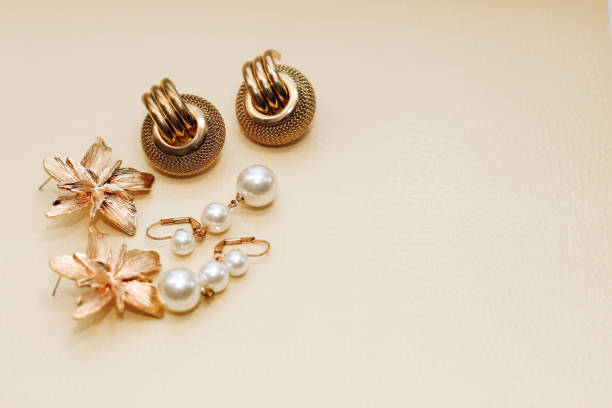istock Gold ornaments from yellow metal on a light background 1487815324