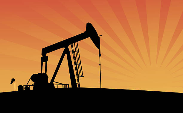 Pumpjack at Sunset vector art illustration