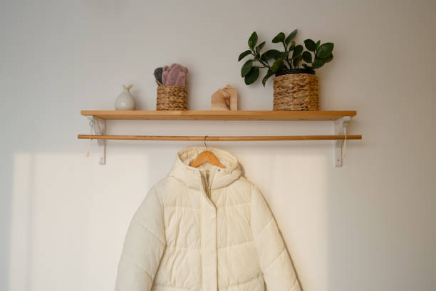 istock A white jacket with a hood hanging on a wooden hanger. 1487818032