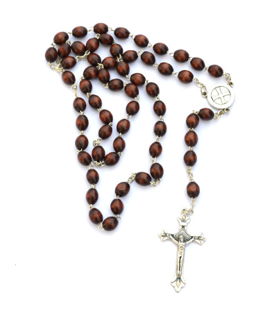 Rosary with brown beads and silver cross isolated on white background