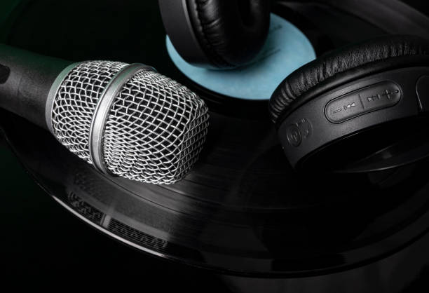 istock Microphone and headphones on vinyl record 1487819263
