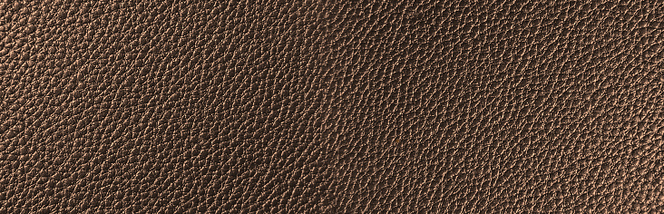 Bronze leather texture. Copper colored web banner. Leather texture shot very close up. Background suitable for any graphic design, poster, website.  Flat lay mockup design.