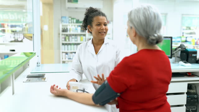 Senior woman measuring blood pressure in pharmacy