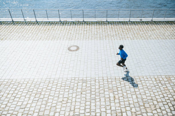 istock young sportsman running alongside river in modern berlin 1487825901
