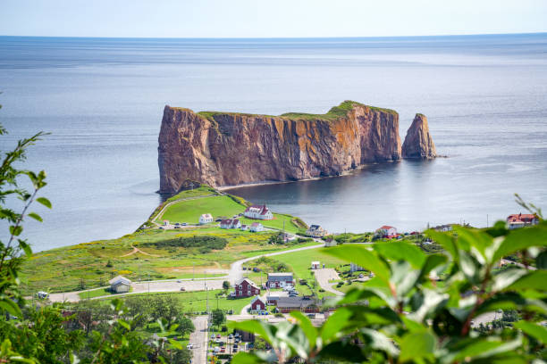 Percé rock from a distance Percé rock from a distance, small town of Percé at the edge, Gaspesie, QC, Canada gaspe peninsula stock pictures, royalty-free photos & images