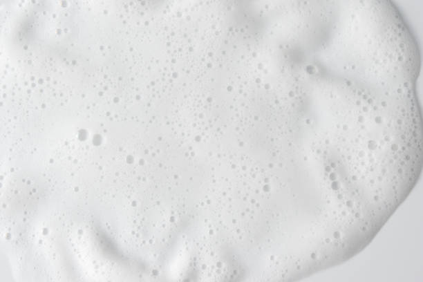 istock Abstract background white soapy foam texture. Shampoo foam with bubbles 1487826483