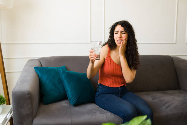 istock Beautiful young woman suffering from teeth sensitivity 1487828388