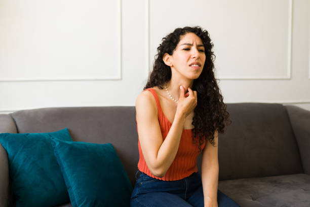 istock Hispanic woman in her 20s suffering from thyroid health problems 1487828405