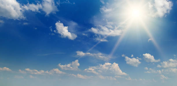 istock clouds and bright sun in the blue sky. Wide photo. 1487829832