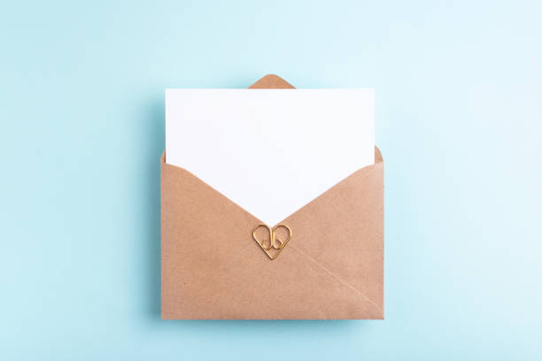 istock White paper card in kraft envelope. 1487829894