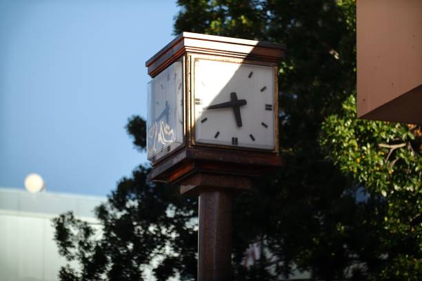 istock Clock situated on a city street with trees in the background 1487837854
