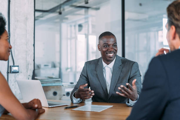 istock Group of business persons talking in the office. 1487838154