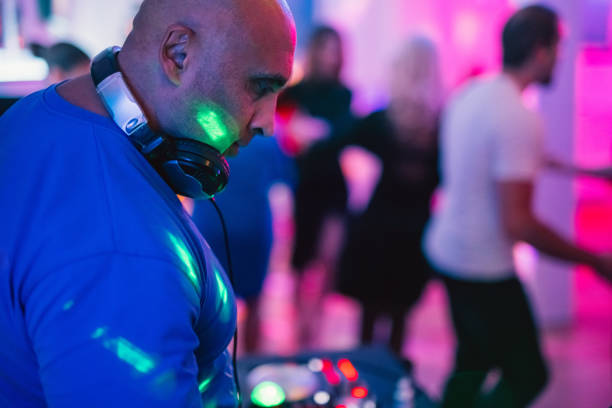 istock DJ playing music at a party indoors 1487838234