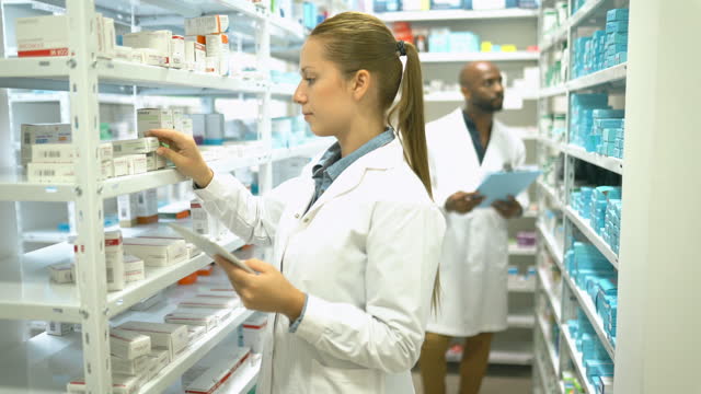 Pharmacist Taking inventory in storage room