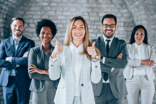 istock Confident businesswoman and her team. 1487839253