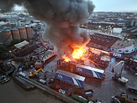 industrial scrapyard on fire. recycling plant fire on the bank of the river Hull. Kingston upon Hull