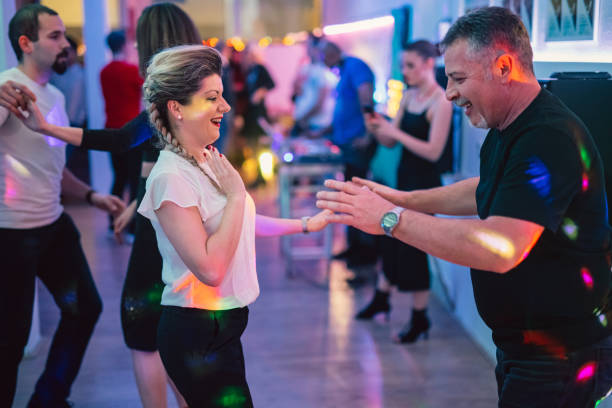 istock Man and woman dancing salsa at the party 1487840439