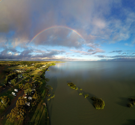 Aerial view of  Lake Albert outside of Meningie South Australia with rainbow at dawn