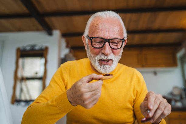 istock Senior caucasian Man Enjoy Breakfast at Home with Jam and Biscuit 1487842419