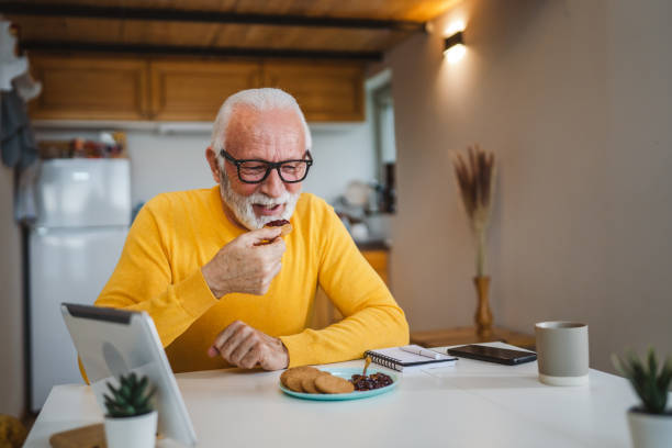 istock Senior caucasian Man Enjoy Breakfast at Home with Jam and Biscuit 1487842421