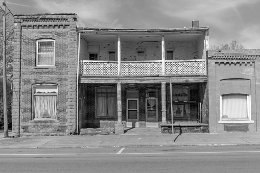 Rural architecture in black and white. Small town USA, two story brick facade with a balcony overlooking country life.