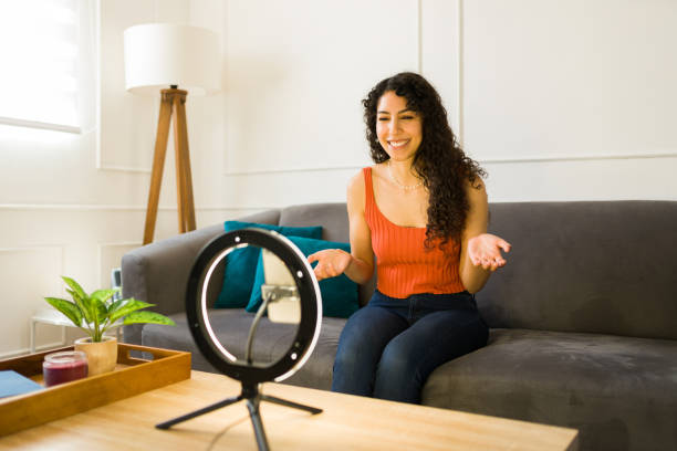 istock Attractive young woman influencer doing a live stream from home 1487843405