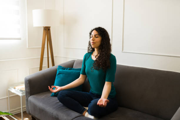 istock Hispanic woman doing breathing exercises during a home meditation 1487843513