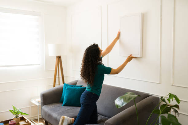 istock Hispanic woman putting up decorations on the wall 1487843609