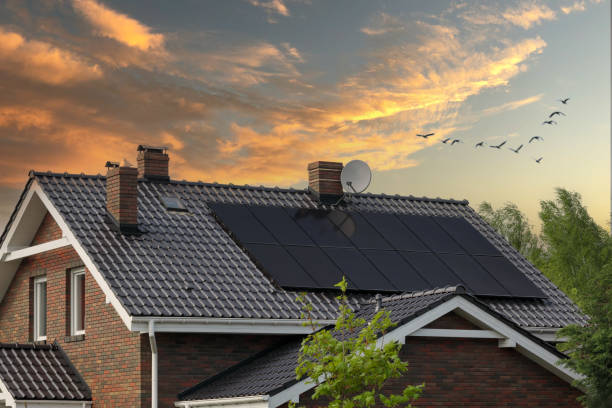 brick house, solar panels, beautiful sunset. roof and photovoltaic. - solar panel fotos imagens e fotografias de stock