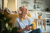 Young woman listening to the music and enjoying at home