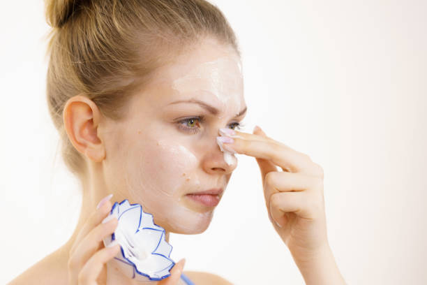 istock Girl apply cream cosmetic 1487850034