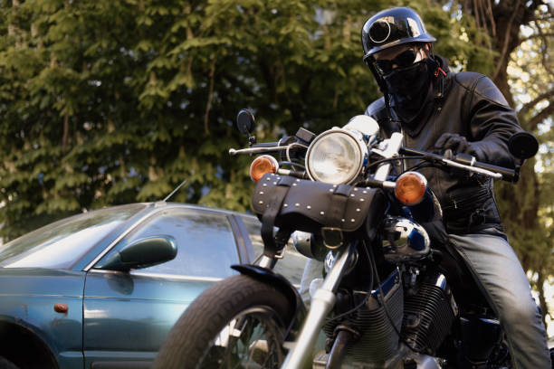 istock Biker in a helmet and glasses on a chopper motorcycle with a wardrobe trunk 1487850188