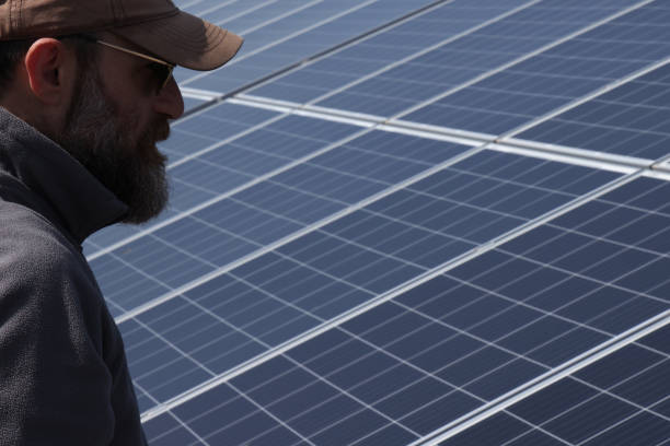 istock Bearded man checking solar panels on his farm 1487851160