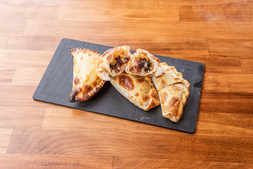 Argentine puff pastry empanadas stuffed with bacon and cheese, halved