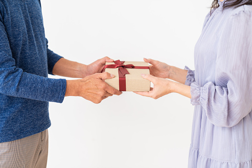 asian senior age couple , present , hands