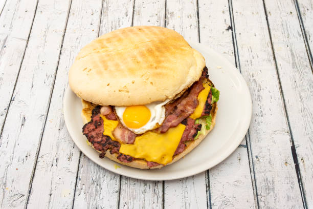 Wild-sized burger with the typical fried egg, strips and strips of bacon and cheddar cheese and lots of lettuce