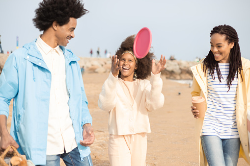 Portrait of a happy African American family going on a picnic on the beach