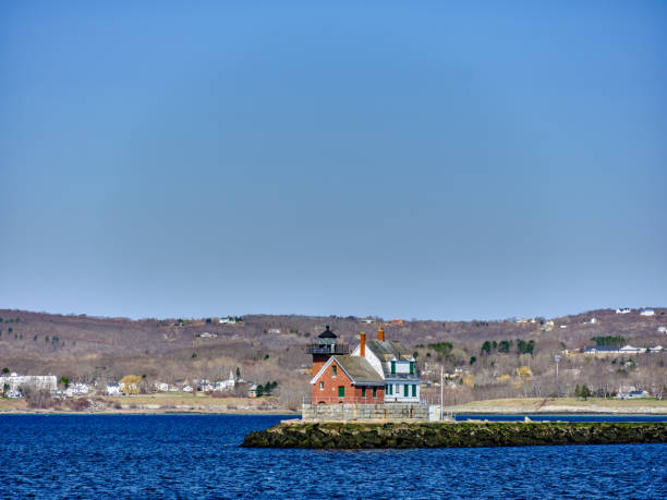 lumière du matin sur le phare et la jetée de rockland breakwater à rockland maine vue depuis le traversier vinalhaven en direction de l’eau libre avec la ville de rockland maine en arrière-plan - rockland breakwater light photos et images de collection