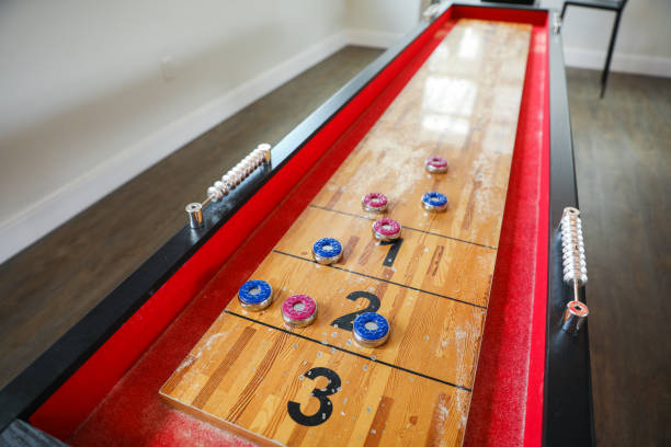 istock Shuffleboard is a game of precision and strategy, where players slide weighted discs down a narrow court to reach scoring areas. The sport represents the pursuit of accuracy and patience 1487870793