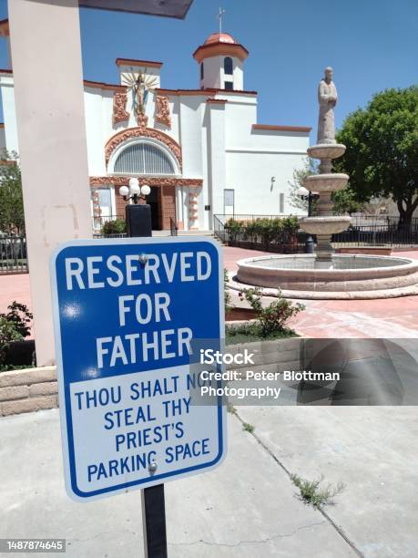 Humorous Sign On Not Stealing A Priests Parking Space In A Church Parking Lot Stock Photo - Download Image Now