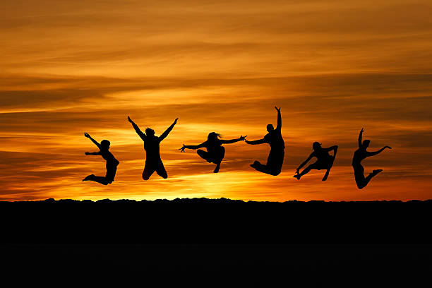 istock silhouette of friends jumping for fun 148787474